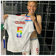 Quinn holding a rainbow jersey